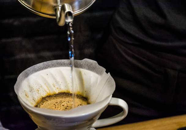 Voorbereiding proces alternatieve methode van koffie in het café. Giet V60, trechter en server. Barista. Frisse drank met cafeïne. - Foto, afbeelding