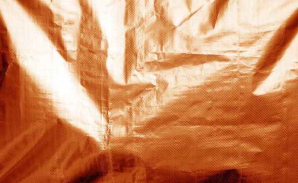 Металізована текстура пластикової обгортки з малинами помаранчевого кольору
. - Фото, зображення