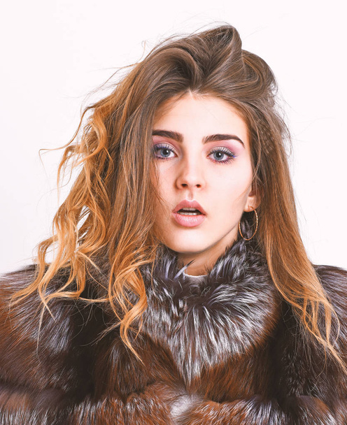 Girl fur coat posing with hairstyle on white background close up. Prevent winter hair damage. Woman makeup calm face hair volume hairstyle. Winter hair care tips you should follow. Hair care concept - Photo, Image