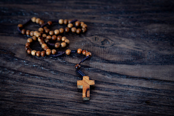 Дерев'яний бісер з хрестом на чорному дерев'яному фоні
 - Фото, зображення
