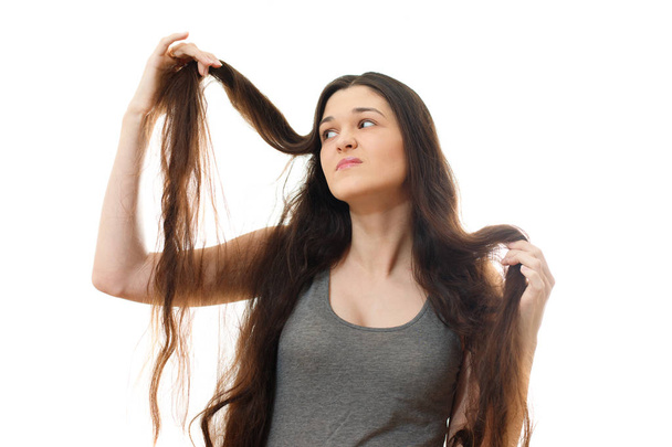 Young woman with problem hair. White background - Photo, image