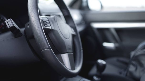Interior view of car with black salon. Steering Wheel - Foto, imagen