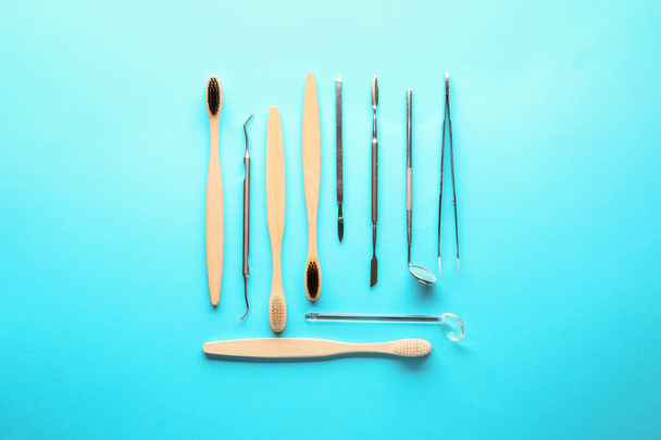 Toothbrushes with dental tools on color background - Φωτογραφία, εικόνα