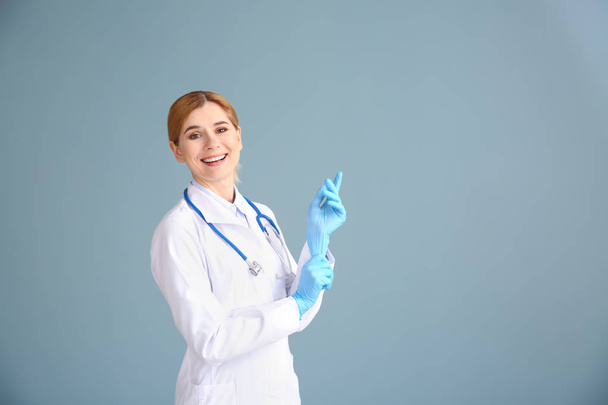 Portrait of beautiful gynecologist on grey background - Photo, Image