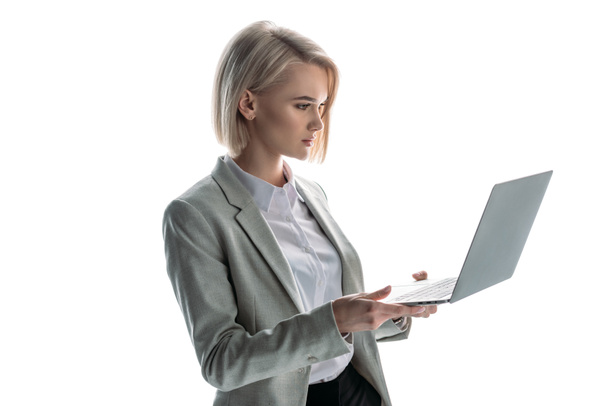pretty, blond, attentive businesswoman holding laptop isolated on white - Photo, Image