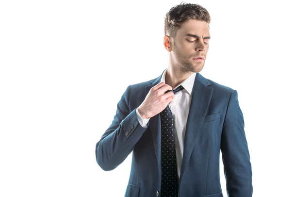 handsome businessman with closed eyes touching tie isolated on white - Φωτογραφία, εικόνα