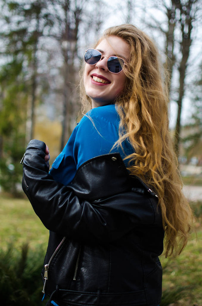 Young smiling girl with curly hair  - Valokuva, kuva
