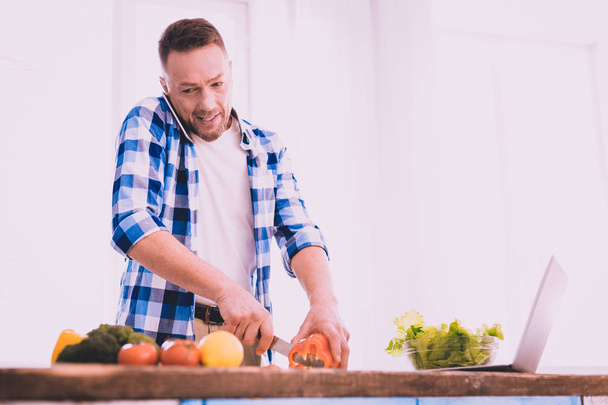 Excited man doing his best to cook something delicious - 写真・画像