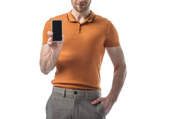 cropped view of man with hand in pocket holding smartphone with blank screen isolated on white - Foto, Imagen