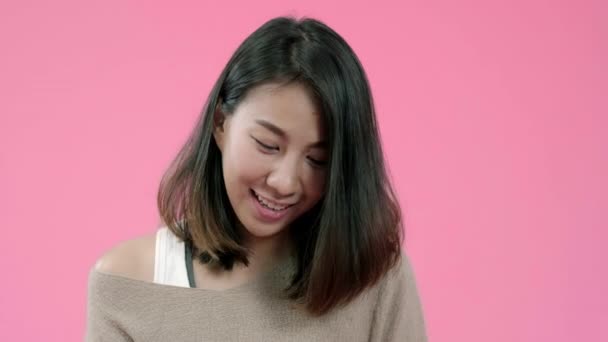 Young Asian woman using smartphone buying online shopping by credit card feeling happy smiling in casual clothing over pink background studio shot. Happy smiling adorable glad woman rejoices success. - Πλάνα, βίντεο