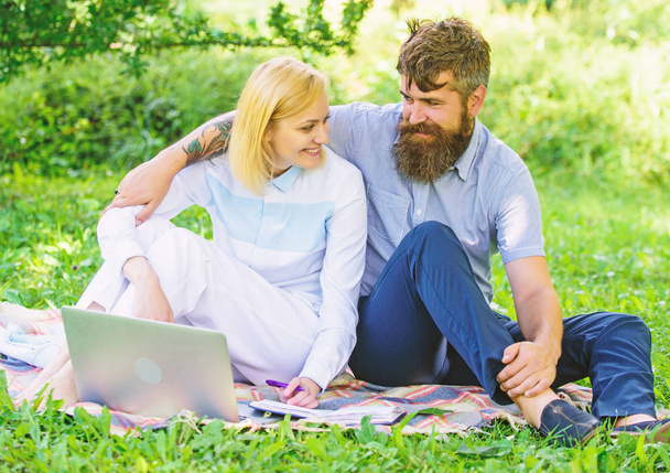 Couple in love or family work freelance. Modern online business. Freelance life benefit concept. How to balance freelance and family life. Couple youth spend leisure outdoors working with laptop - Foto, imagen