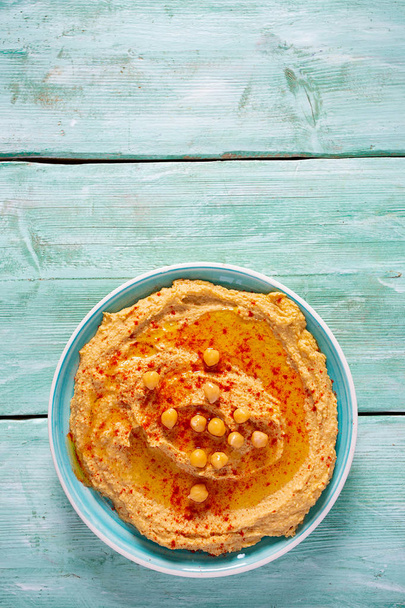 hummus on a turquoise surface - Foto, afbeelding