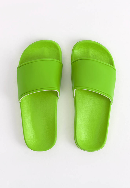 Bright green, lime stylish rubber slippers, on a white and gray background, mock-up - Fotografie, Obrázek