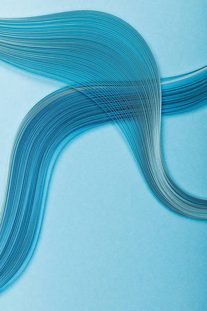 top view of blue abstract paper lines on blue background - Foto, Imagem
