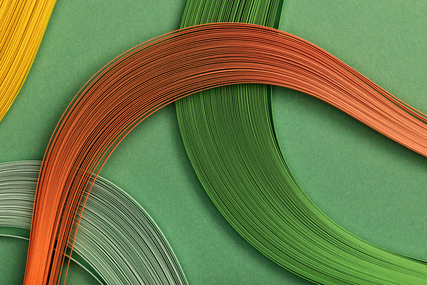 close up of multicolored lines on green background - Foto, afbeelding