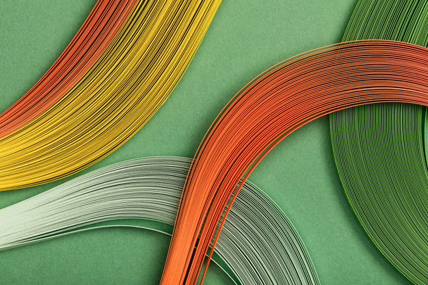 close up of yellow, orange and green abstract lines on green background - Foto, Bild