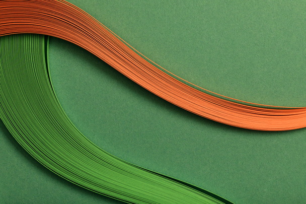 close up of green and orange abstract lines on green background - Фото, зображення