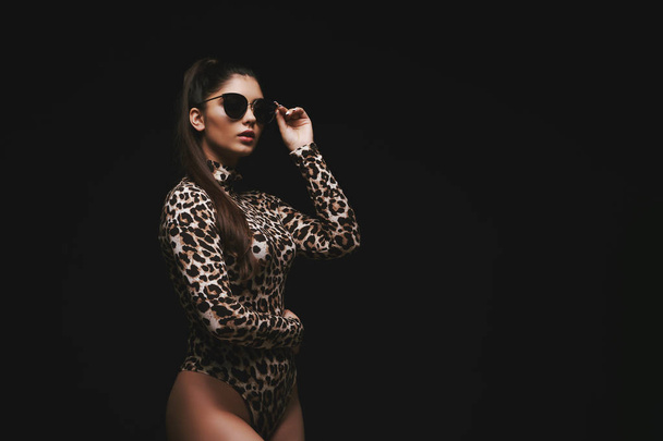 Alluring young brunette in leopard bodysuit - Photo, Image