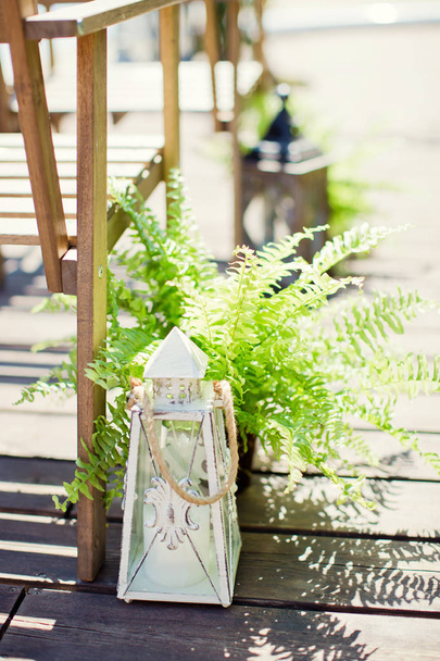 vintage lanterns with candles and fern - 写真・画像