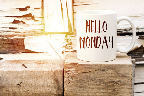 text HELLO MONDAY on cup of aromatic coffee on wooden cube - Foto, Bild