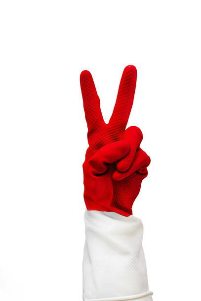 Hand in red rubber glove with two fingers are folded, showing what sign everything is cool. Isolate on a white background. cleaning is excellent, fun cleaning, easter update, easter bunny, medicine - Photo, Image