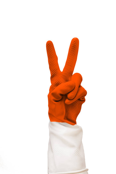 everything is cool sign made of orange medical gloves. two fingers are folded. Isolate on a white background. cleaning is excellent, fun cleaning, easter update, easter rabbit - Foto, imagen
