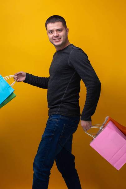 Image of brunet man with shopping bags - Zdjęcie, obraz