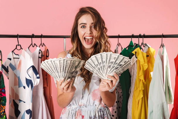 Image of happy girl standing near wardrobe while holding money f - Fotografie, Obrázek