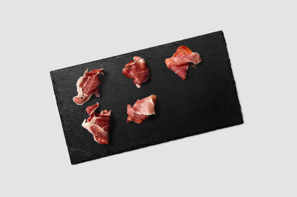Black Rectangular stone plate with meat on white background.High resolution photo. - Photo, image