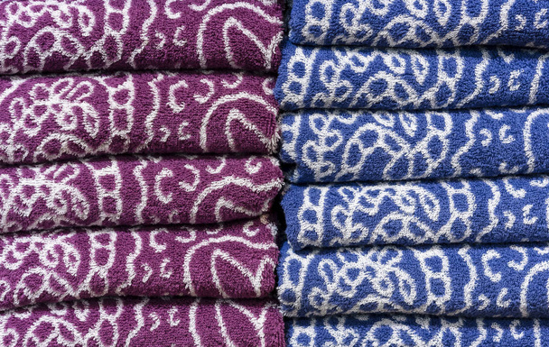 Folded terry towels on the counter of the store. Background towels. - Photo, Image