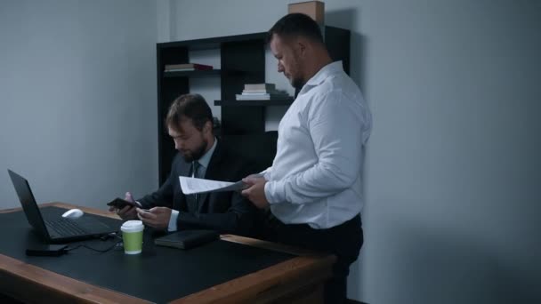 two businessmen argue about signing a contract of documents in the office, the chief and subordinate, slow motion - Video