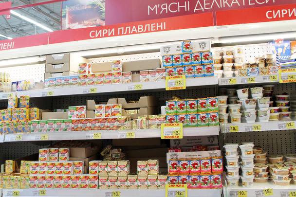 Wide range of processed cheese on shelves of supermarket. Choice of milky goods - Photo, Image