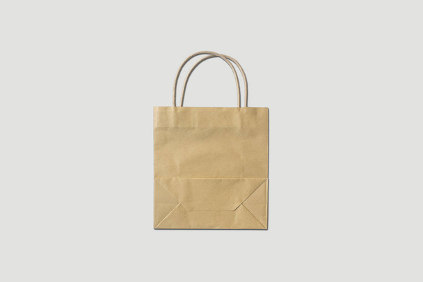 Brown paper bag on soft gray background. - Photo, Image