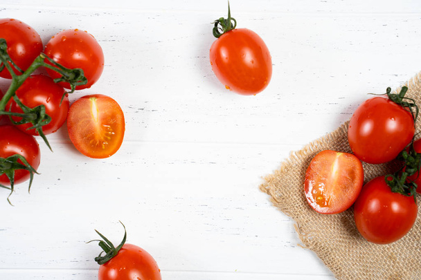 Fresh cherry tomatoes on a white wood background. - Photo, Image