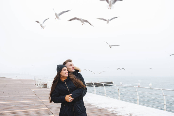 Young happy loving couple walking at the beach outdoors. - Foto, Imagen