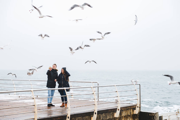 Young happy loving couple walking at the beach outdoors. - 写真・画像