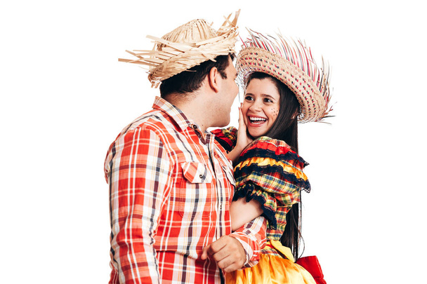 Brazilian couple wearing traditional clothes for Festa Junina - June festival - dancing isolated on white background - Фото, изображение