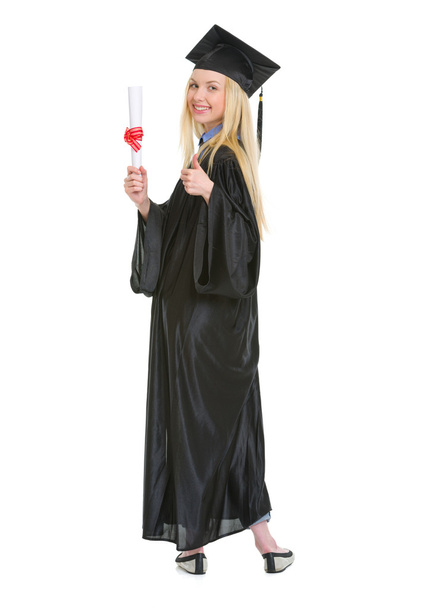 Full length portrait of young woman in graduation gown showing d - Foto, Imagem