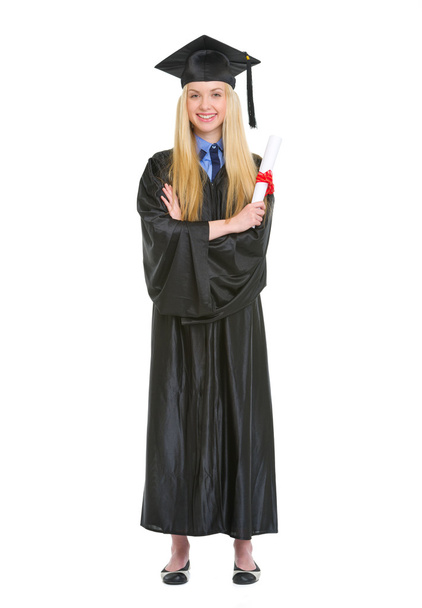 Smiling young woman in graduation gown holding diploma - Фото, зображення