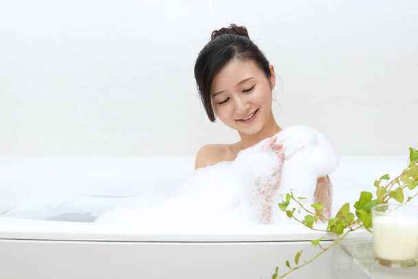 リラックスできるお風呂に美しい若い女性 - 写真・画像