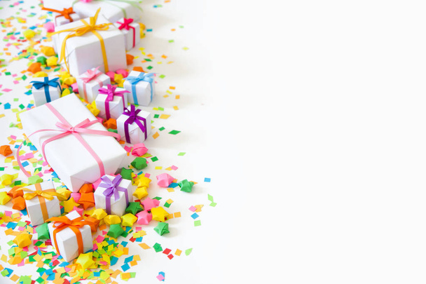 Bright gifts for a party, birthday or a new year. Confetti, stars, garlands, crackers. - Foto, imagen