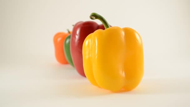 Yellow, Red, Green and Orange Peppers Against White - Line Arrangement - Dolly Right - Footage, Video