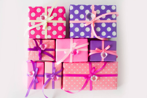 Colored gift boxes with colorful ribbons. white background. Gifts for St. Valentine's Day or a birthday. - 写真・画像