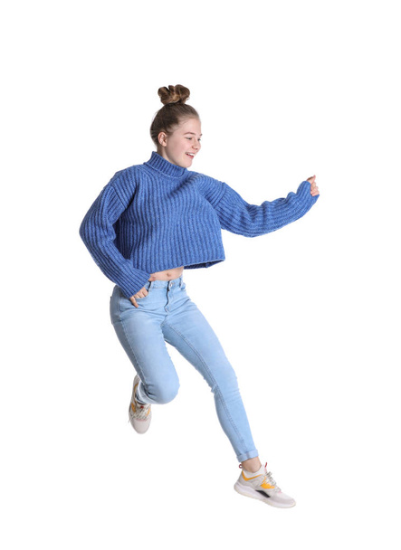 Pretty teenage girl jumping on white background - Foto, afbeelding