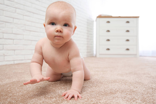 Cute little baby crawling on carpet indoors - Foto, afbeelding