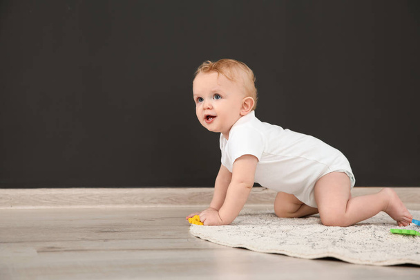Cute little baby crawling on rug indoors, space for text - Фото, изображение