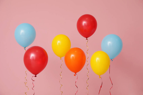 Bright balloons on color background. Celebration time - Foto, Imagem