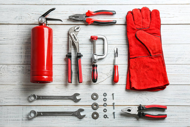 Flat lay composition with construction tools on wooden background - Foto, afbeelding