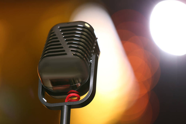 Retro microphone against festive lights, space for text. Musical equipment - Foto, Imagem