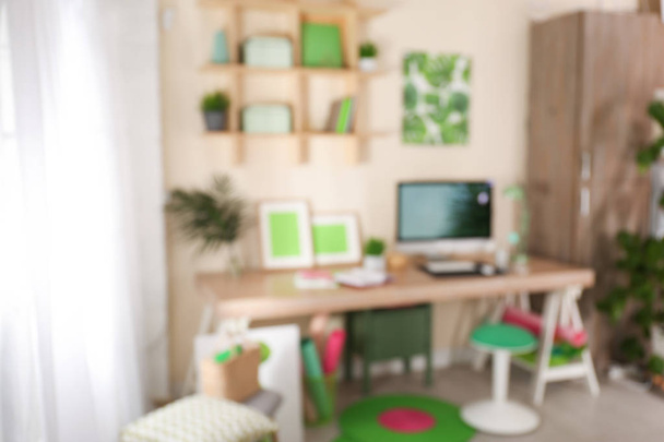 Blurred view of comfortable workplace with computer at home - 写真・画像